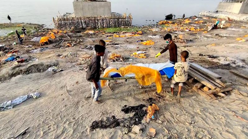 Horor na břehu Gangy: Indické děti za úplatu pálí těla obětí koronaviru